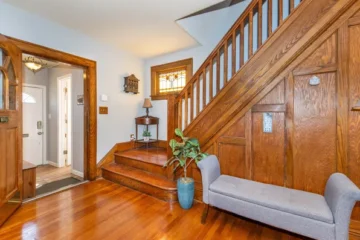 Entryway with hardwood staircase and stained glass windows at 164 Day St, Clifton NJ