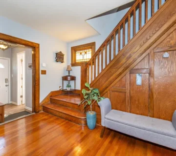Entryway with hardwood staircase and stained glass windows at 164 Day St, Clifton NJ