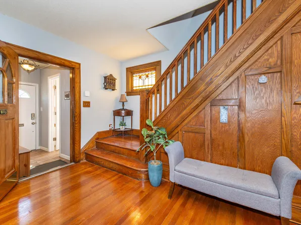 Entryway with hardwood staircase and stained glass windows at 164 Day St, Clifton NJ