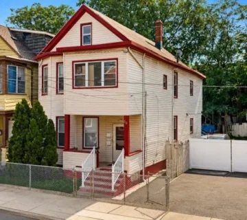 Front exterior of the two-family home at 33 Vreeland Ave, Passaic NJ