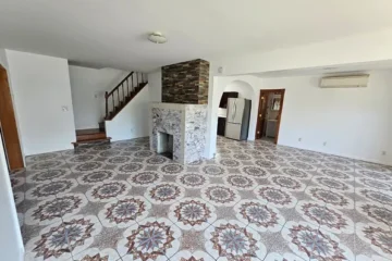 Living room with decorative tile floor and fireplace at 175 Park Ave, Passaic NJ