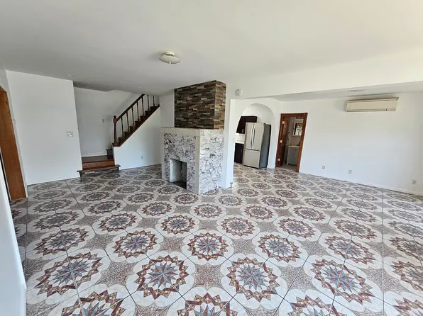 Living room with decorative tile floor and fireplace at 175 Park Ave, Passaic NJ