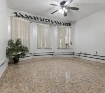 Living room with tile flooring and ceiling fan at 33 Vreeland Ave, Passaic NJ