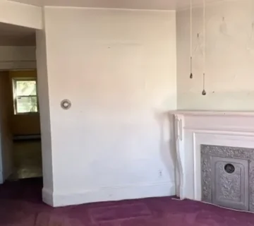 Living room with decorative fireplace at 68 Hoover Ave, Passaic NJ