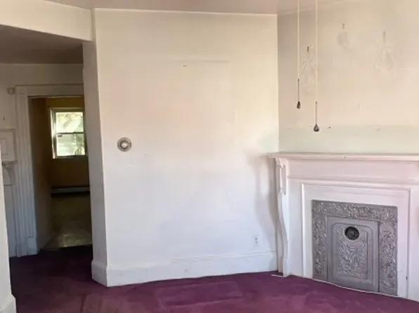 Living room with decorative fireplace at 68 Hoover Ave, Passaic NJ